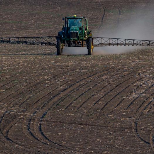 machine spraying fertilizer on crop