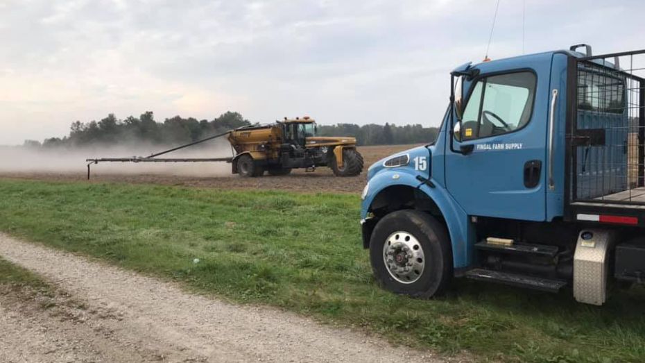 Fingal Farm Supply truck overlooking machinery tending to pasture